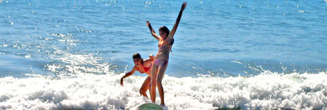 Boy Laying on Surfboard